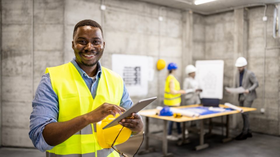 Portrait of civil engineer or construction worker holding tablet.